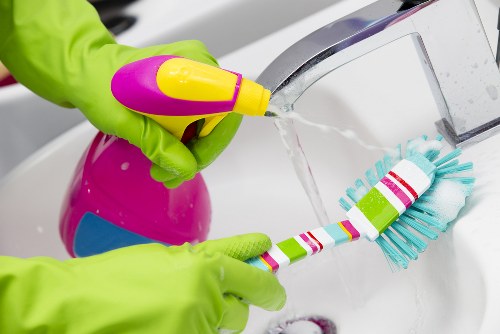 Kitchen surfaces being cleaned during domestic cleaning in Bow