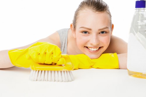 Cleaning staff sanitising shared office surfaces in Bow