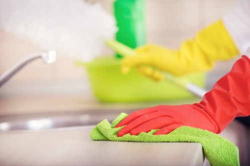 Professional cleaner applying safe product handling during oven cleaning